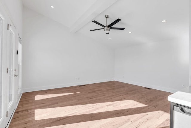 empty room featuring visible vents, wood finished floors, and baseboards