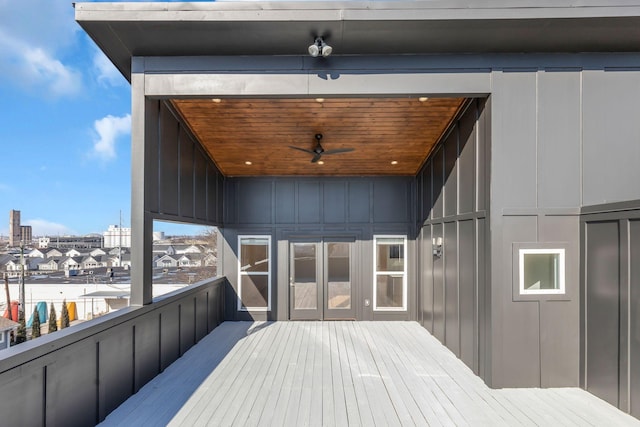 wooden deck with elevator and a ceiling fan