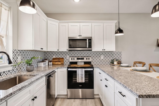 kitchen with sink, white cabinetry, and stainless steel appliances