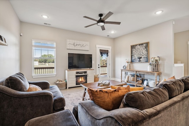 living room featuring ceiling fan and light wood-type flooring