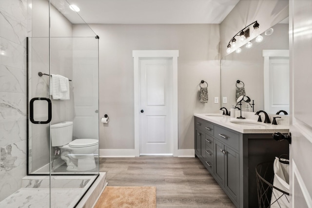 bathroom with vanity, wood-type flooring, an enclosed shower, and toilet