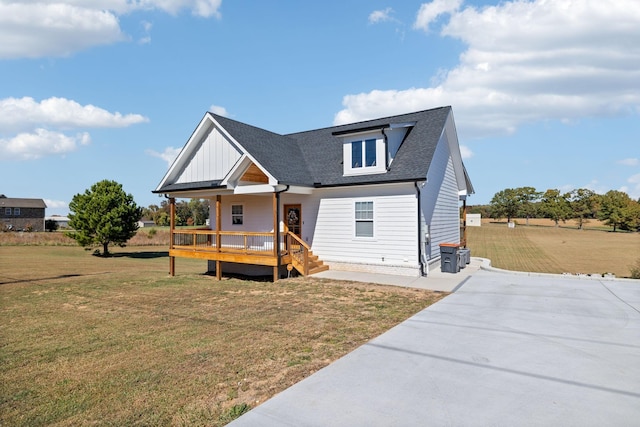 view of front of house with a porch and a front lawn