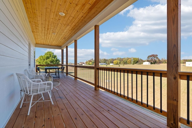 wooden deck featuring a lawn