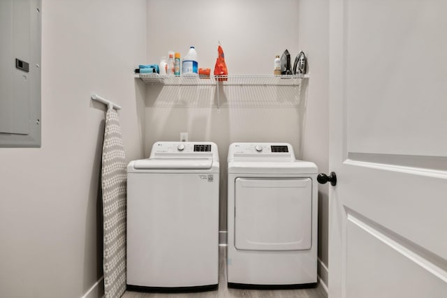 laundry room with washing machine and clothes dryer and electric panel