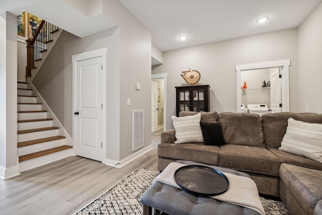 living room featuring hardwood / wood-style floors and washer / dryer