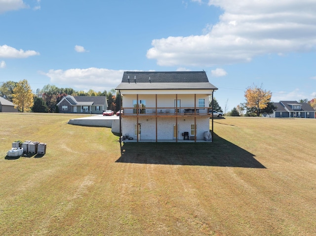 back of property featuring a lawn