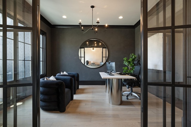 office area with an inviting chandelier, light hardwood / wood-style flooring, and ornamental molding