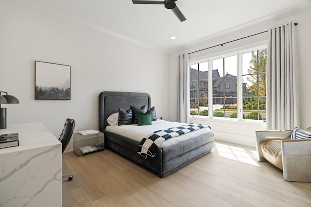 bedroom with ceiling fan and light hardwood / wood-style flooring