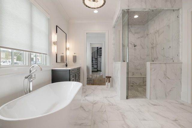 bathroom with plus walk in shower, vanity, and crown molding