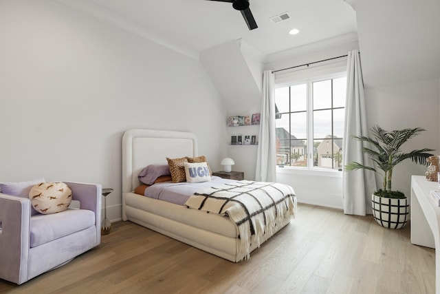 bedroom with light hardwood / wood-style floors, ornamental molding, and multiple windows