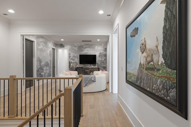 hallway featuring light hardwood / wood-style flooring and ornamental molding