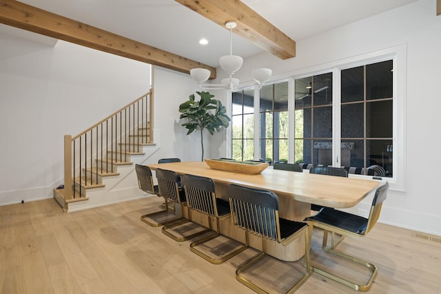 dining room featuring light hardwood / wood-style flooring, beamed ceiling, and a notable chandelier