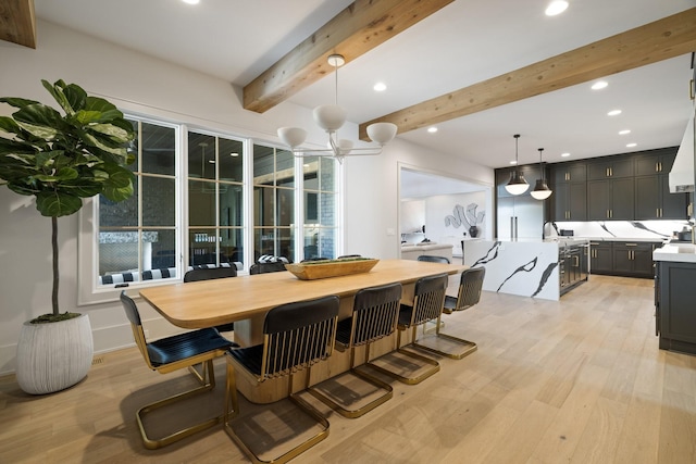 dining room with beamed ceiling, light hardwood / wood-style floors, and a chandelier