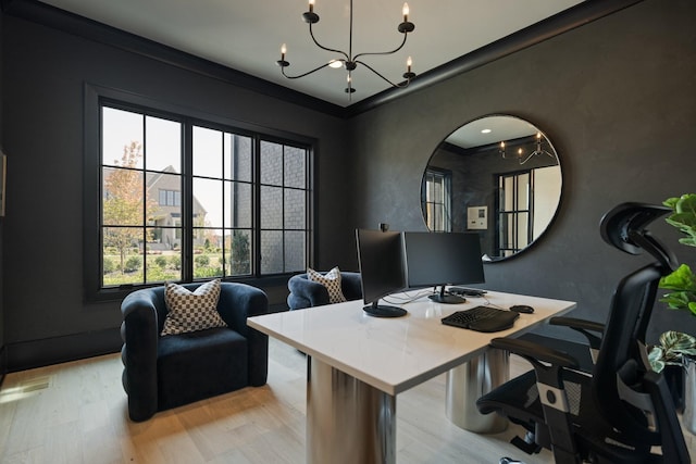 office space with light hardwood / wood-style floors and an inviting chandelier