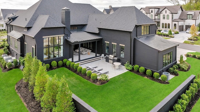 back of house featuring a yard and a patio