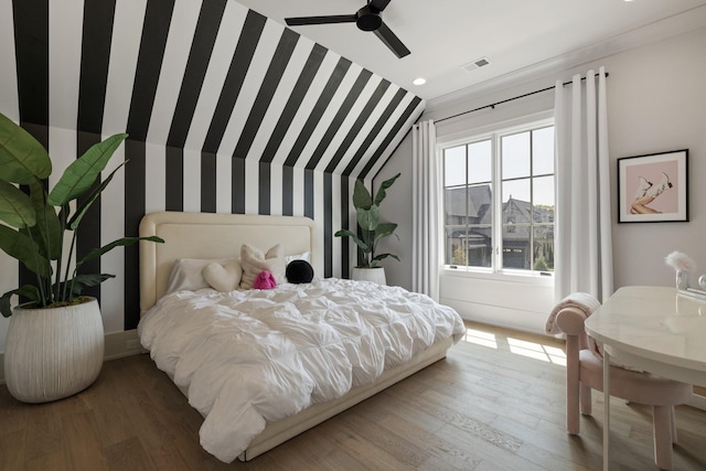 bedroom with ceiling fan, hardwood / wood-style floors, and lofted ceiling