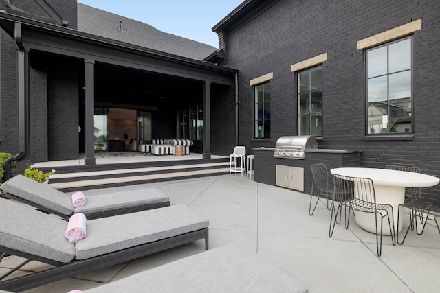 view of patio with outdoor lounge area, a grill, and area for grilling