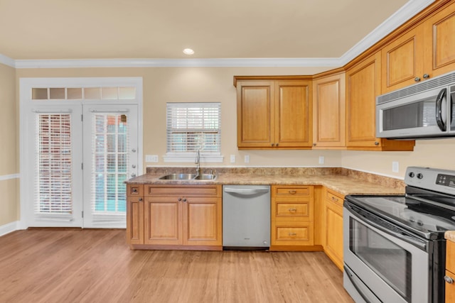 kitchen with sink, light hardwood / wood-style flooring, ornamental molding, and appliances with stainless steel finishes