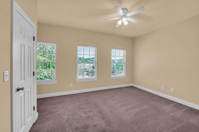 carpeted spare room with ceiling fan