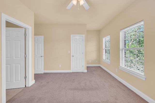 unfurnished bedroom featuring ceiling fan and light carpet