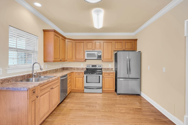 kitchen with appliances with stainless steel finishes, light hardwood / wood-style floors, ornamental molding, and sink