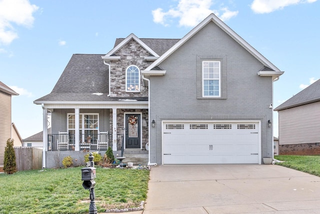 view of front property featuring covered porch, a front lawn, and a garage