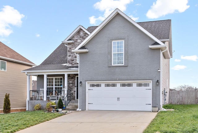 view of front facade with covered porch, a front lawn, and a garage