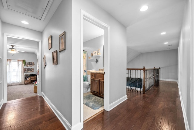 hall featuring lofted ceiling and dark wood-type flooring