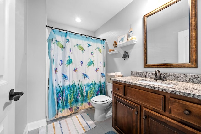 bathroom featuring vanity, tile patterned floors, and toilet