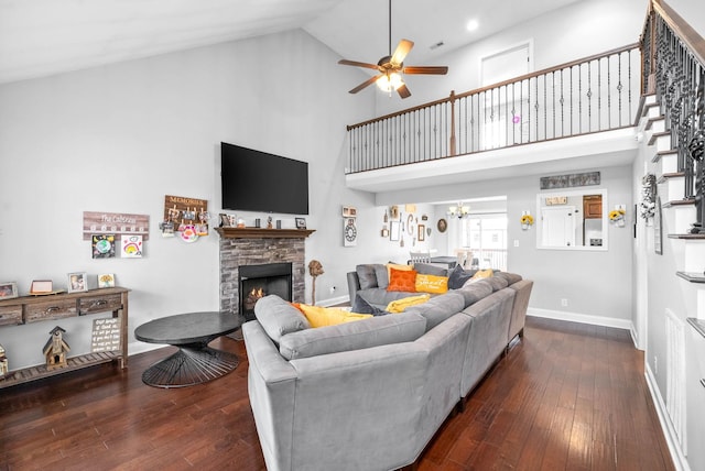 living room with ceiling fan, dark hardwood / wood-style floors, high vaulted ceiling, and a fireplace