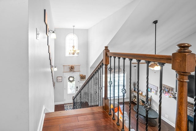 foyer featuring hardwood / wood-style flooring, a chandelier, and plenty of natural light