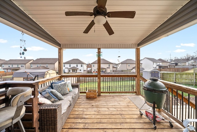 wooden terrace with ceiling fan and outdoor lounge area