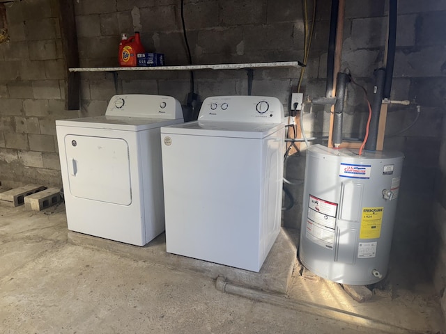 washroom with washer and clothes dryer and water heater