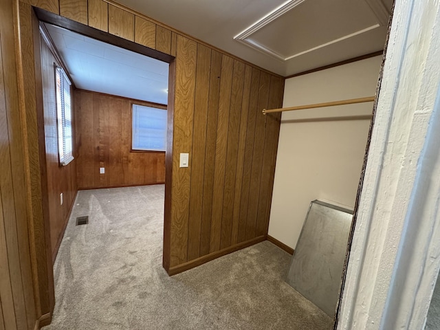 walk in closet featuring light colored carpet