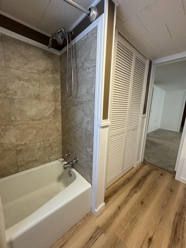 bathroom featuring hardwood / wood-style flooring and tiled shower / bath combo