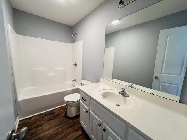 full bathroom with hardwood / wood-style floors, vanity, toilet, and tub / shower combination