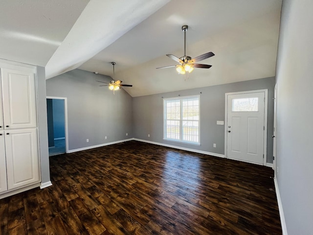 interior space with ceiling fan, dark hardwood / wood-style flooring, and lofted ceiling