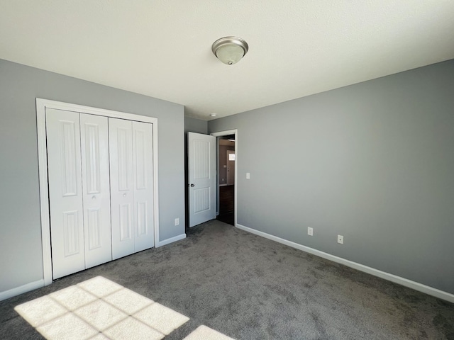 unfurnished bedroom with a closet and carpet