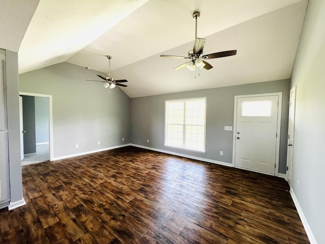 unfurnished living room featuring dark hardwood / wood-style flooring, vaulted ceiling, and ceiling fan