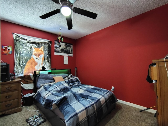 carpeted bedroom featuring a textured ceiling and ceiling fan