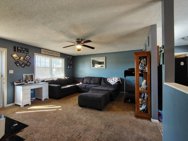 carpeted living room featuring ceiling fan and a textured ceiling