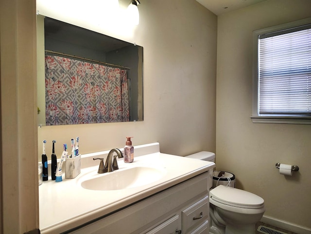 bathroom with vanity and toilet