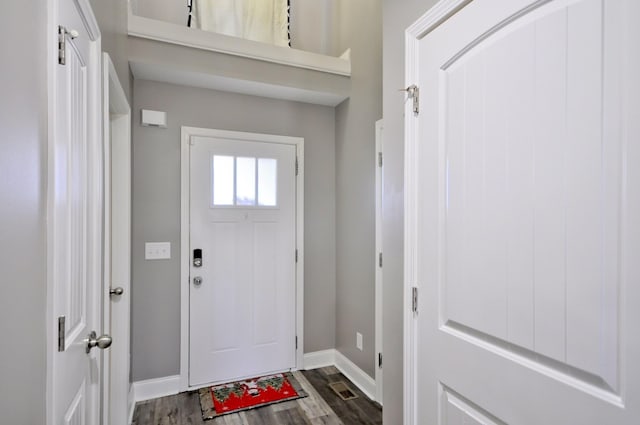 entryway with dark hardwood / wood-style flooring