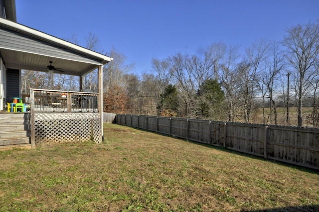 view of yard featuring a wooden deck and ceiling fan