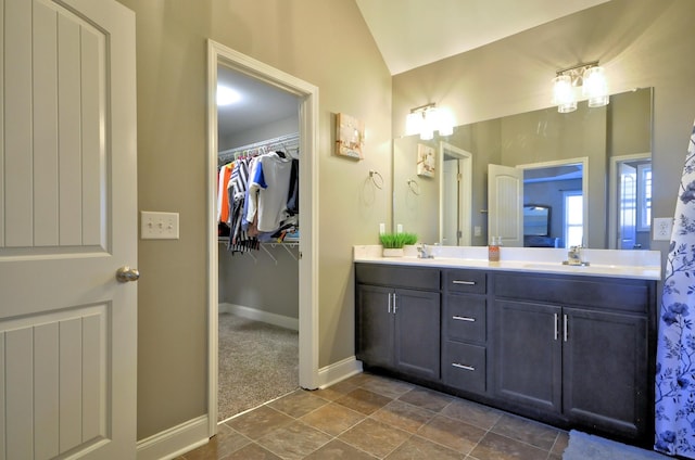 bathroom featuring lofted ceiling and vanity