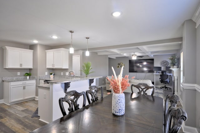 dining space with dark hardwood / wood-style floors, beamed ceiling, sink, coffered ceiling, and ceiling fan