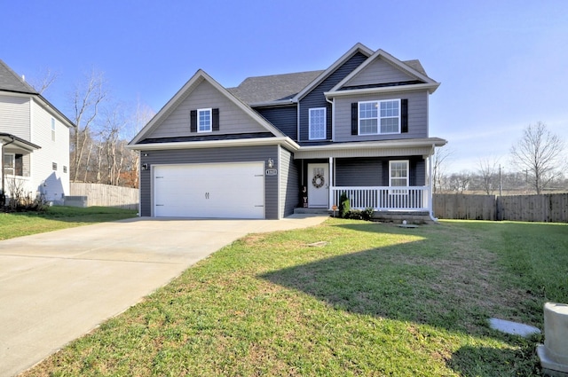 view of front of house with a garage, a front lawn, and covered porch