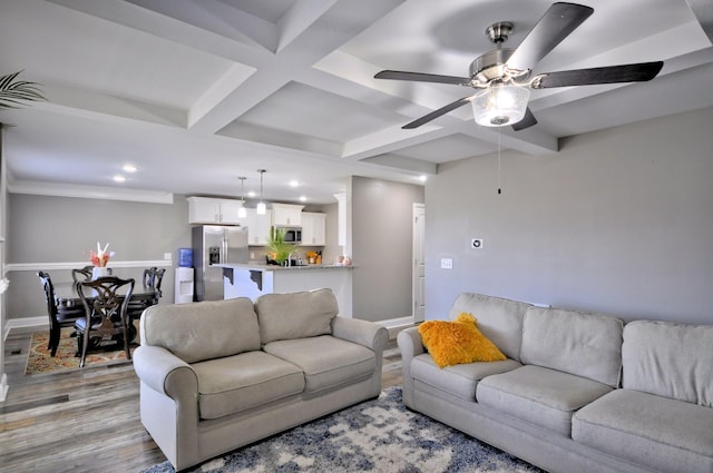 living room with coffered ceiling, ceiling fan, beam ceiling, and light hardwood / wood-style floors