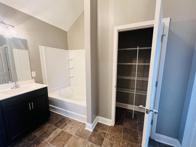 bathroom with vanity and lofted ceiling