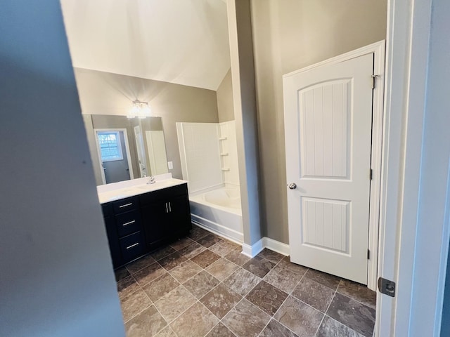 bathroom with vanity, tub / shower combination, and vaulted ceiling